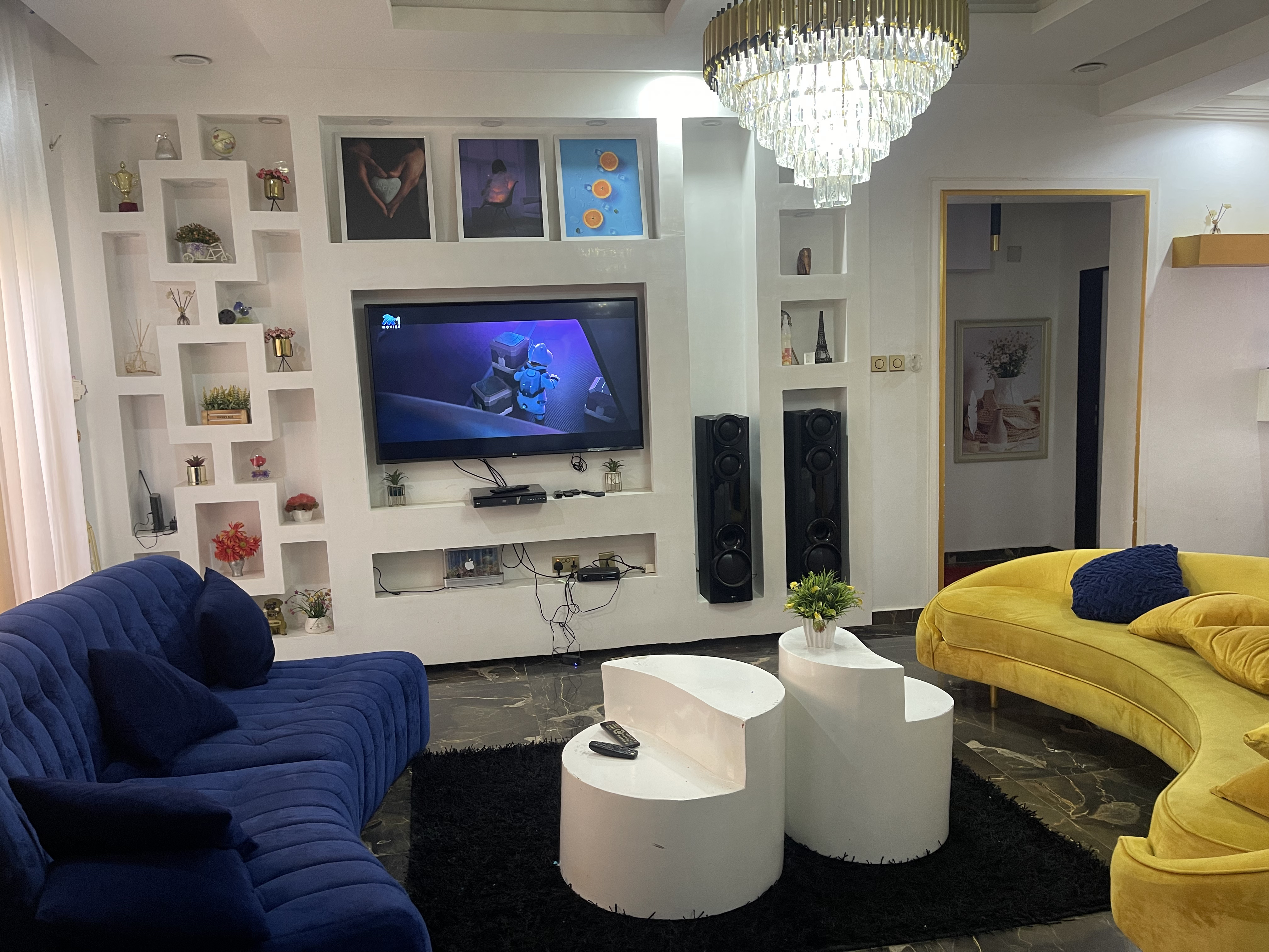 Luxury living room with curved golden sofa and modern entertainment center