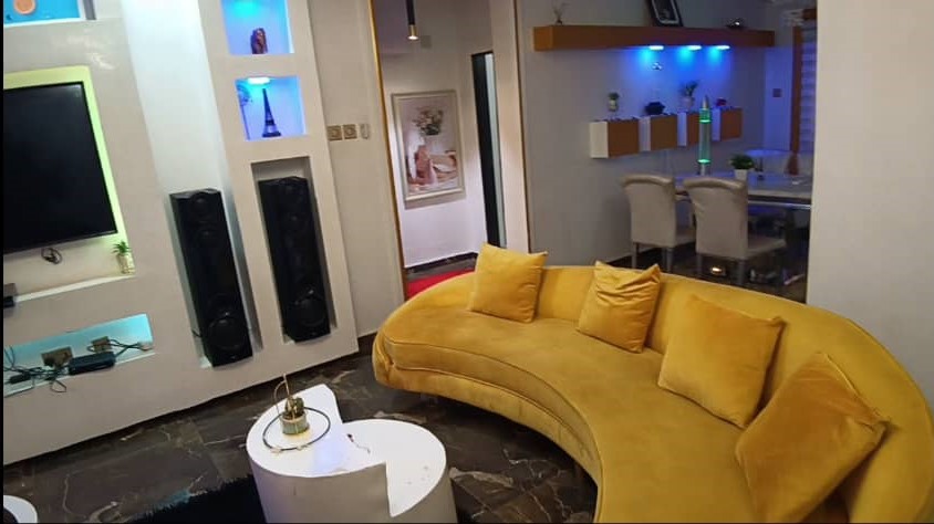 Another view of the elegant living space with blue accent lighting